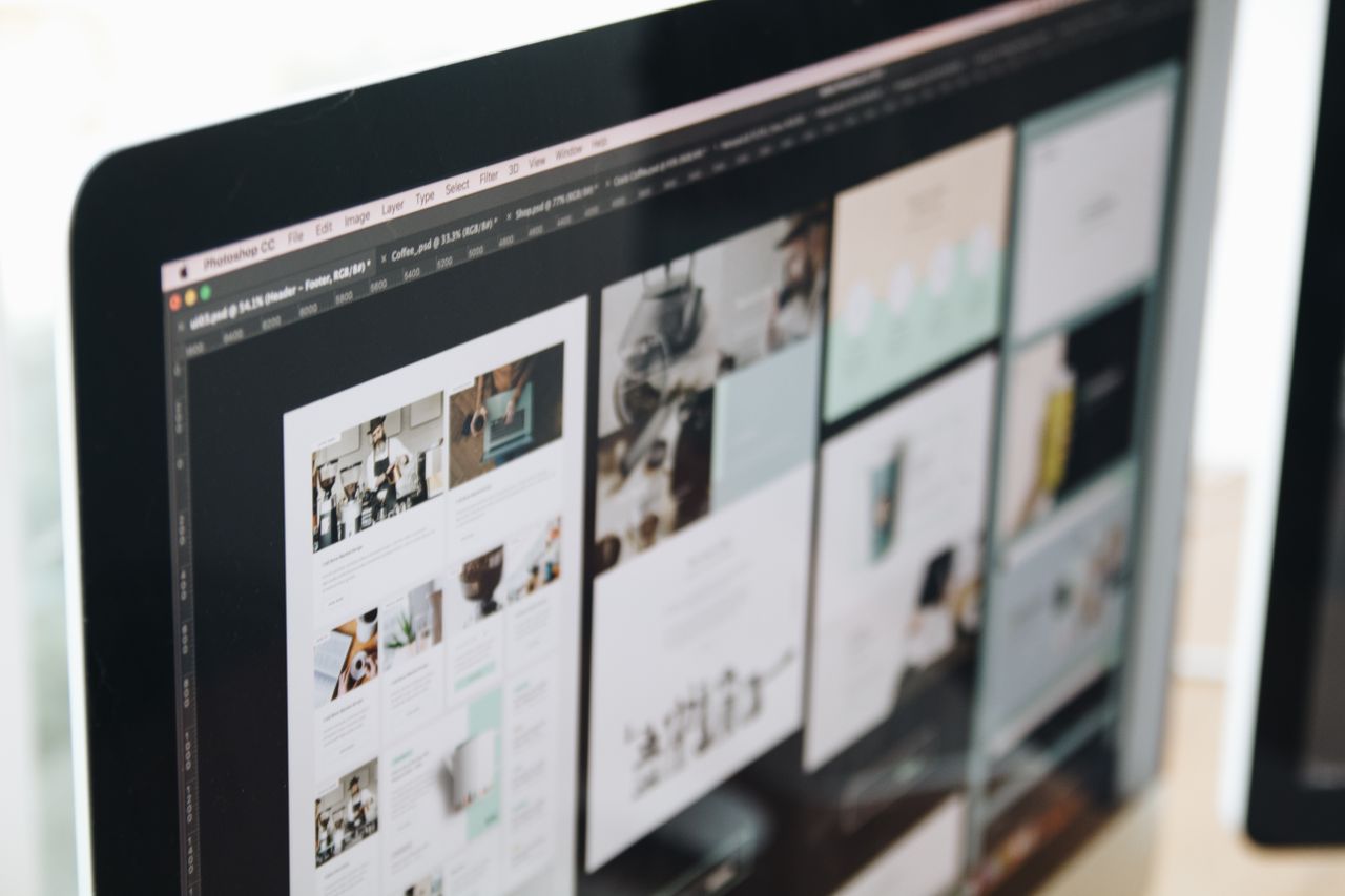 A contemporary computer screen showing web design work, highlighting creative visuals in a workspace.